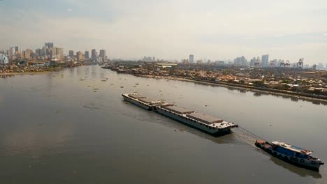 Aerial-view-tugboat-and-barge-in-the-sea.Philippines,-Manila