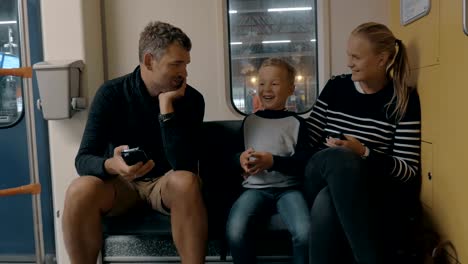 View-of-happy-family-in-the-railway-trip-using-smartphone,-Amsterdam,-Netherlands