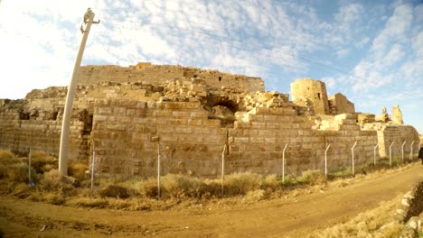 a-ruined-medieval-castle-Harran-Kalesi-fenced-off,-close-to-the-border-between-Turkey-and-Syria