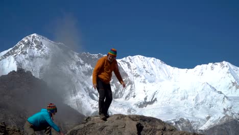 A-man-helps-a-woman-to-climb-to-the-top