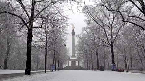 The-Angel-of-Peace-on-the-top-of-Friedensengel-monument-in-Munich,-Germany-during-the-snow-srorm