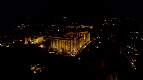 Aerial-night-video-of-iconic-ancient-Acropolis-hill-and-the-Parthenon-at-night,-Athens-historic-center