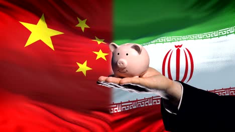 China-investment-in-Iran,-hand-putting-money-in-piggybank-on-flag-background