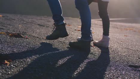 Close-up-shot-of-young-loving-couple-walking-on-beach-in-Iceland-during-sunset,-slow-motion