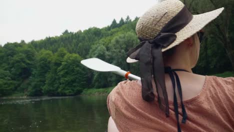 Young-girl-canoeing-on-a-beautiful-lake-and-looking-around