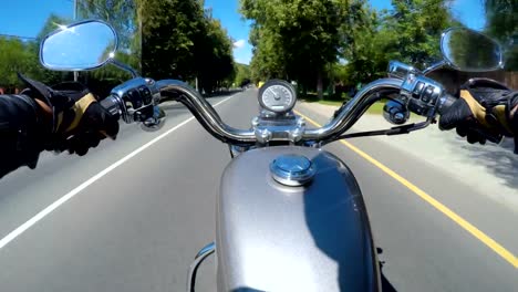 Riding-a-motorcycle.-Biker-rides-on-the-road-with-a-first-person.