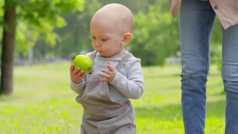Mother-and-Baby-Boy-with-Apple-in-Park