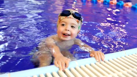 Portrait-of-little-baby-swimming-in-swimming-pool