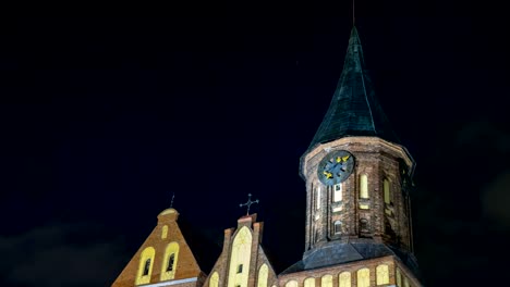 Illumination-on-a-historic-building.-Historic-Landmark.-Time-lapse.-Cathedral-of-Kant-in-Kaliningrad.-Old-medieval-at-night-against-the-sky.-An-ancient-tower-with-a-clock.-Timelapse.