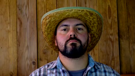 Man-in-straw-hat-on-wooden-background