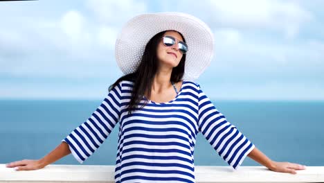 Slow-motion-attractive-woman-tourist-in-hat-and-sunglasses-smiling-and-admiring-of-amazing-sky