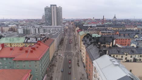 Stockholm-city-street-aerial-view.-Drone-shot-flying-over-street-and-buildings-in-Södermalm-district.-Cityscape-skyline-in-The-Capital-of-Sweden.-Skrapan-skyscraper-building-in-the-background