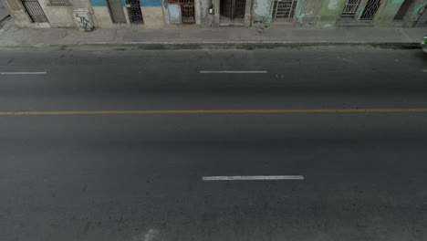 high-angle-aerial-establishing-shot-of-classic-car-on-Malecon-street-of-Havana,-Cuba