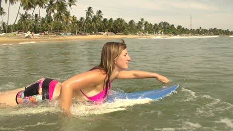 SLOW-MOTION:-Female-surfer-paddling-out