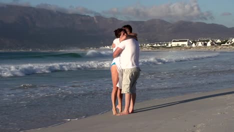 Man-and-woman-enjoying-romantic-embrace-on-the-beach,-Cape-Town,South-Africa