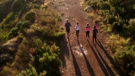 Multi-ethnic-group-of-athletes-running-on-a-footpath