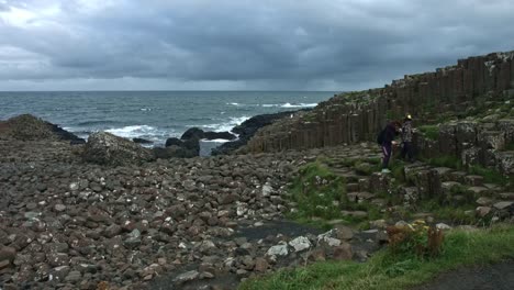 4k-Shot-of-Tourists-on-Giant's-Causeway,-Northern-Ireland