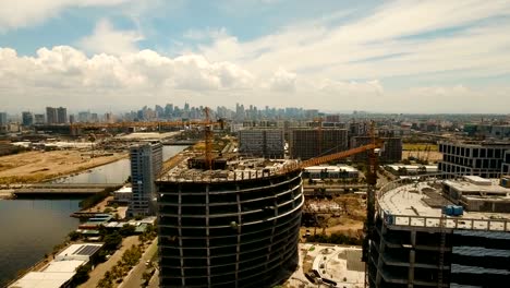 Building-under-construction-with-cranes-in-the-city.-Philippines,-Manila,-Makati