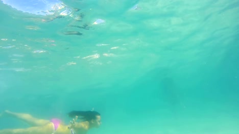 Brunette-female-swimming-underwater-in-the-pool-in-uhd,-stock-video