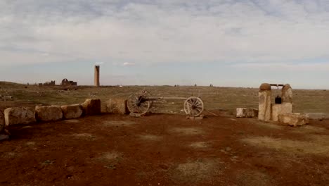 Antiguos-carritos-de-madera-y-bien-árabe,-desierto,-cámara-en-directo,-la-torre-en-la-distancia