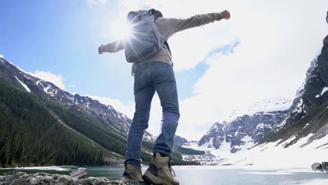 Young-hiker-reaching-lake-arms-outreached-in-nature-for-success-and-freedom