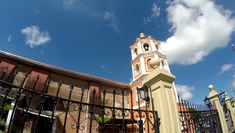 Colonial-16th-century-Spanish-built-of-Saint-Paul-the-First-Hermit-Cathedral-also-known-as-San-Pablo-Cathedral,-showing-her-surrounding-iron-fence-at-the-east-side-nave-brick-walls.-tracking-shot