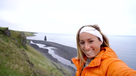 Selfie-of-girl-at-Hvitserkur-basalt-stack-along-the-eastern-shore-of-the-Vatnsnes-peninsula,-in-northwest-Iceland.-People-travel-lifestyles-concept