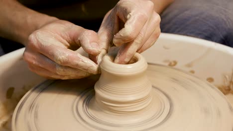 Man's-hands-making-clay-ware-on-the-potter's-wheel