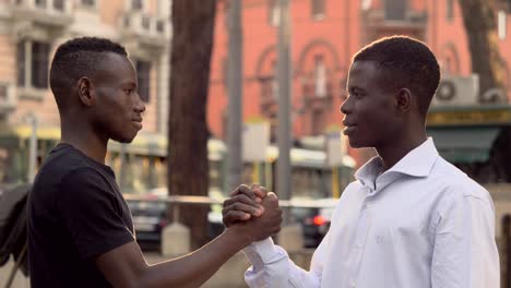 young-smiling-African-men-greeting-in-the-street.