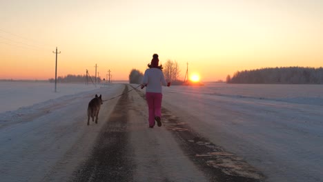 Woman-Runs-With-A-Dog-On-A-Winter-Evening-On-The-Way-To-Meet-The-Scarlet-Sunset