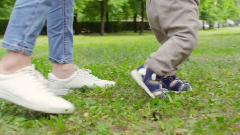 Unrecognizable-Mother-Teaching-Baby-to-Walk