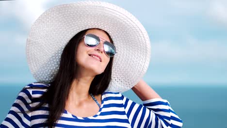 Slow-motion-woman-admiring-beautiful-sky-reflecting-in-sunglasses-and-seascape