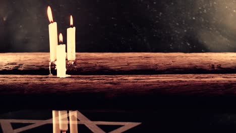 Burning-candles-on-a-ola-oak-table-and-the-Star-of-David,-rotation-360-degrees-against-dark-background.