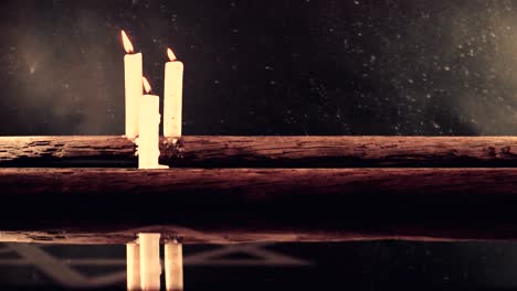 Burning-candles-on-a-ola-oak-table-and-the-Star-of-David,-rotation-360-degrees-against-dark-background.