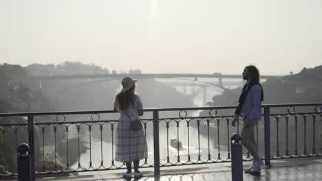 Couple-embracing-and-kissing-on-bridge