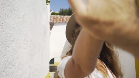 Smiling woman-with-stretched-out-hands-between-buildings