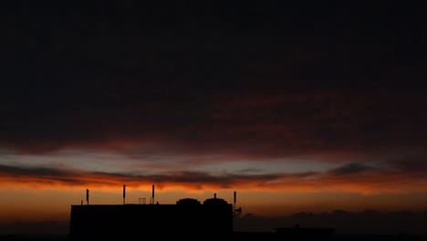 HD-Time-Lapse---Bright-Sunset-Over-Silhouetted-Building