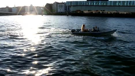 Girl-boy-on-boat-relax-flow-town-lake-river-canal