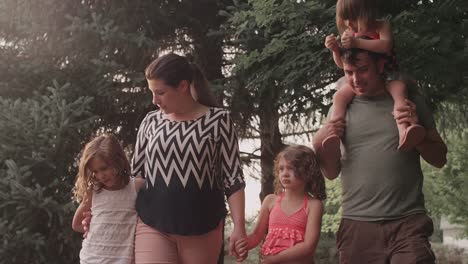 A-family-walking-together-under-trees