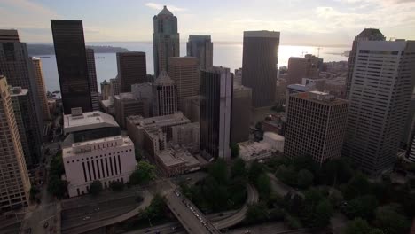 Aerial-View-of-Downtown-City-Skyscraper-Buildings-with-Water-Background-on-Sunny-Day