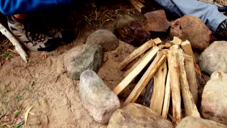 Close-up-of-hiker-couple-preparing-a-camp-fire