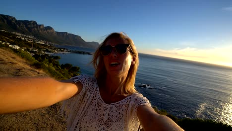 Young-woman-taking-selfie-with-seascape,-Cape-Town