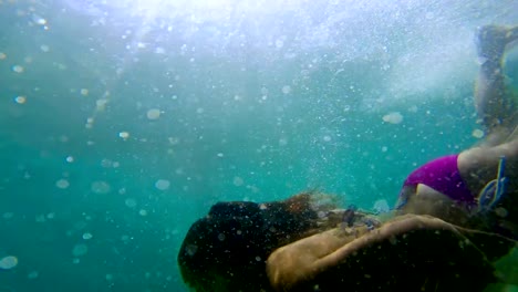 Woman-swimming-in-underwater-bubbles