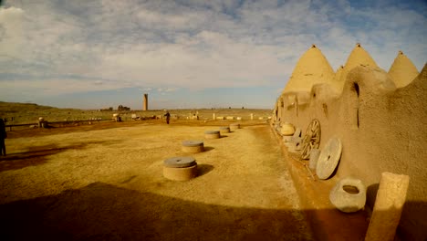 girl-goes-to-the-traditional-old-clay-houses-in-the-southeast-of-Turkey,-on-the-border-with-Syria