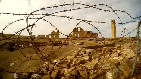 behind-the-barbed-wire-the-ruins-of-the-Muslim-University,-close-to-the-border-between-Turkey-and-Syria