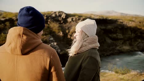 Young-loving-couple-standing-in-the-beautiful-valley-in-sunny-day-and-hugging,-enjoying-the-view-and-romantic-date