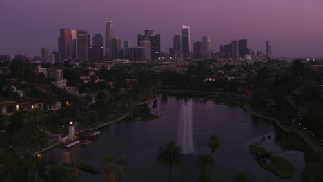 Los-Angeles,-Flying-over-Echo-Park-with-downtown-Los-Angeles-in-distance.