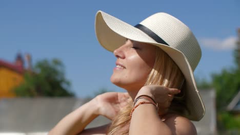 Portrait-beautiful-woman-in-hat-looking-around-while-resting-in-country-garden.-Rotation-camera