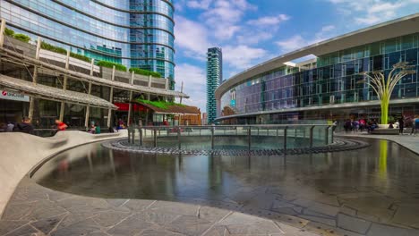 Italy-milan-city-sunny-day-famous-modern-block-fountain-square-panorama-4k-timelapse