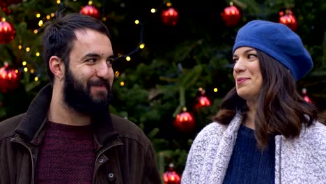 happy-funny-couple-laughing-and-smiling-at-camera-at-Christmas-time